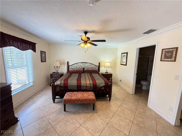 a room that has a bed and a chair in it