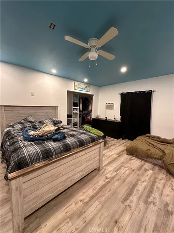 a view of a bedroom with a large bed and chandelier