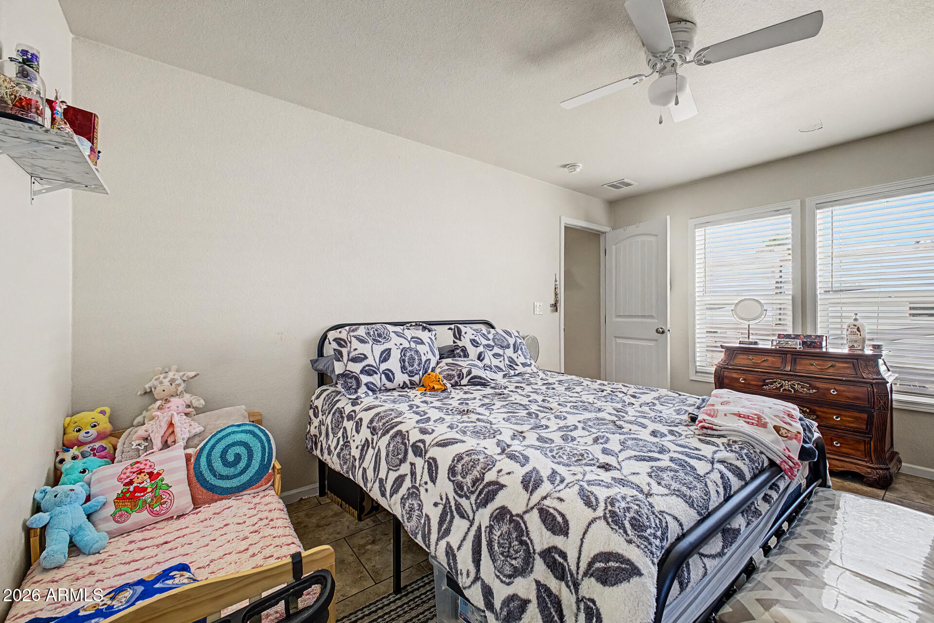 625 West McKellips Road, Unit 393 Mesa, AZ 85201 - Photo 11 of 21 a bedroom with a bed that has a blanket on it and next to a window