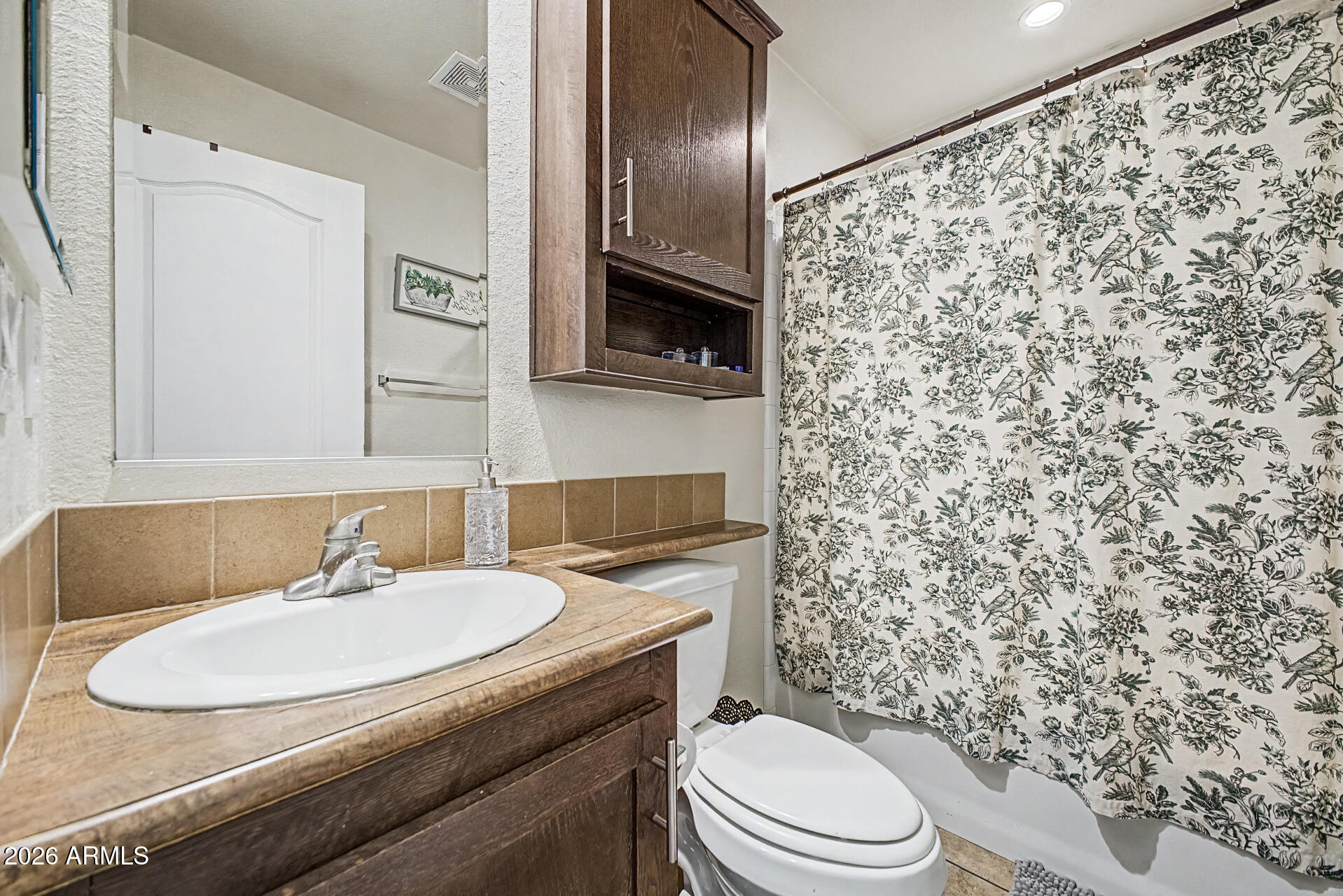 625 West McKellips Road, Unit 393 Mesa, AZ 85201 - Photo 18 of 21 a bathroom with a granite countertop toilet sink and mirror