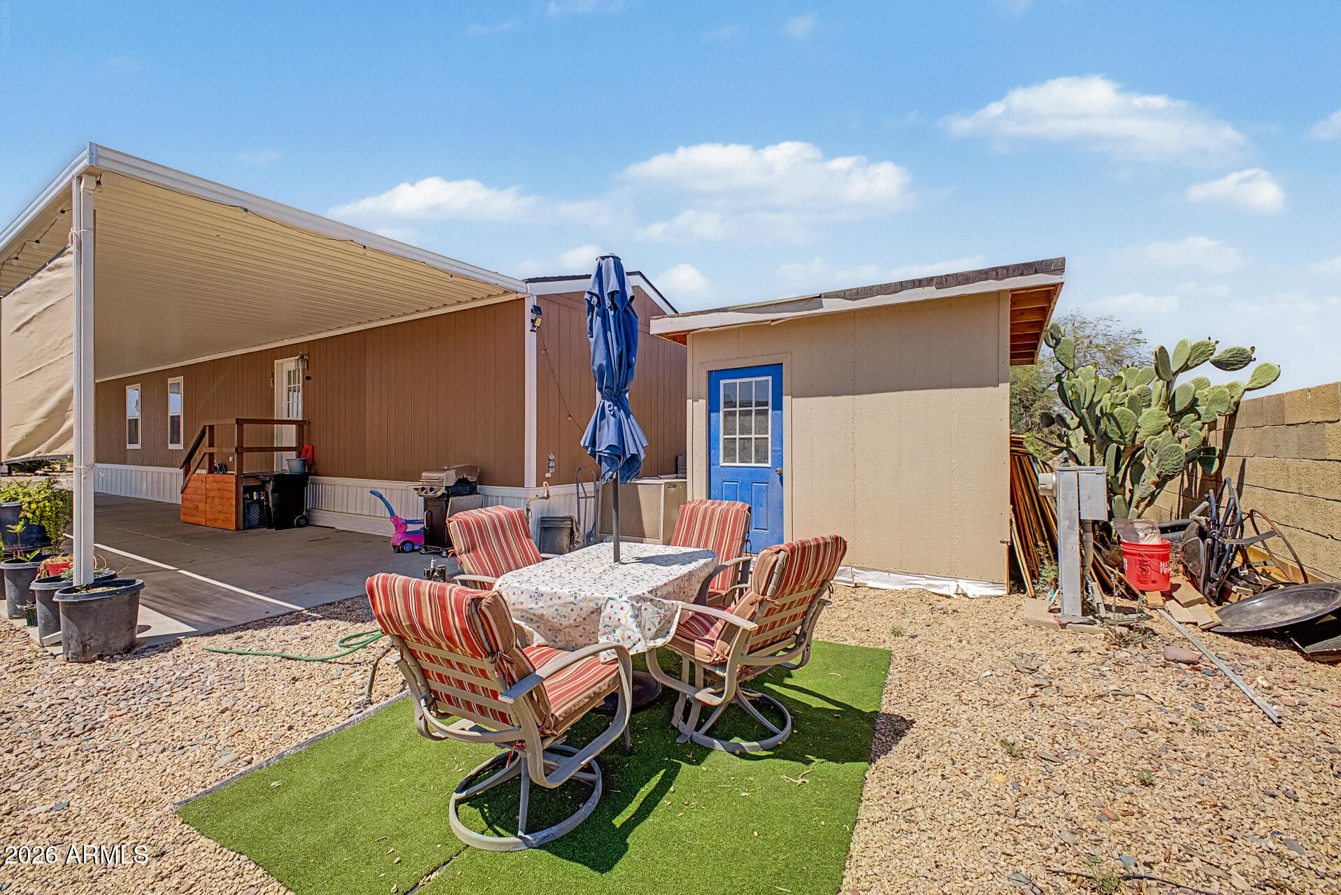 625 West McKellips Road, Unit 393 Mesa, AZ 85201 - Photo 21 of 21 a view of a backyard with furniture and a patio