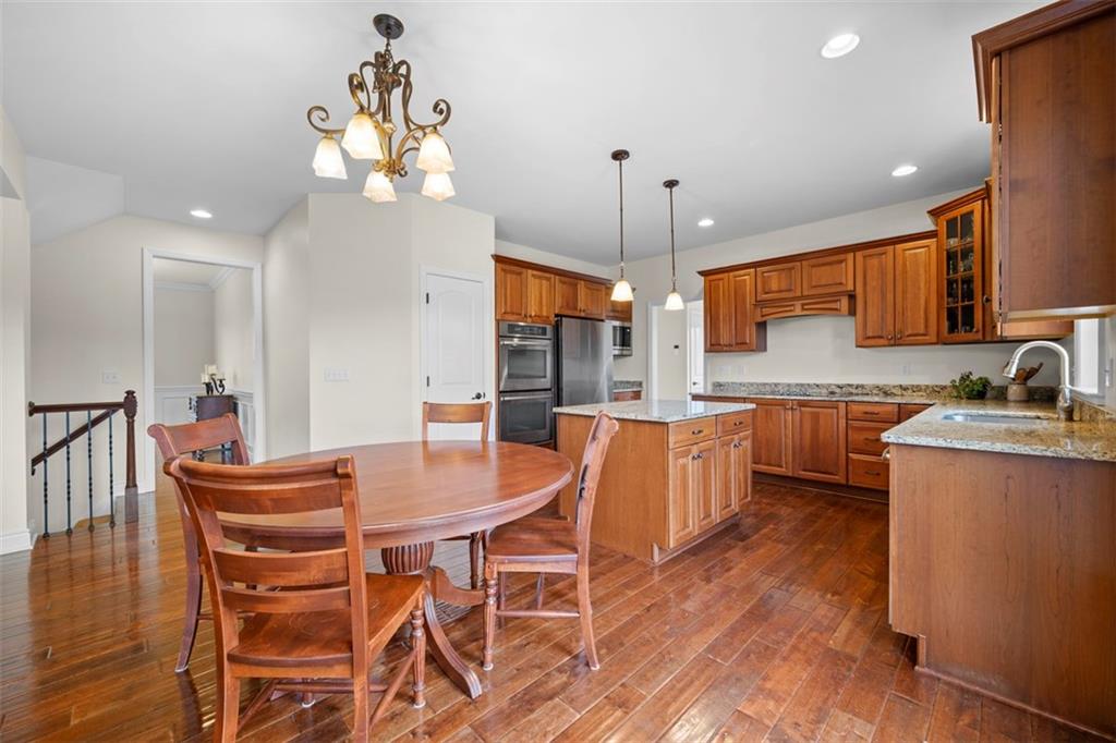 136 Hammond Road Mars, PA 16046 - Photo 12 of 48 a kitchen with stainless steel appliances kitchen island granite countertop a sink a stove a dining table and chairs