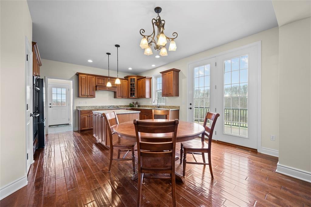 136 Hammond Road Mars, PA 16046 - Photo 13 of 48 a view of a dining room with furniture a chandelier and wooden floor