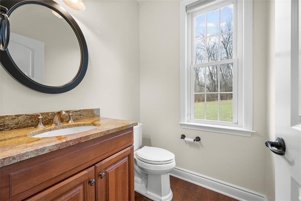 136 Hammond Road Mars, PA 16046 - Photo 17 of 48 a bathroom with a granite countertop toilet a sink and a mirror