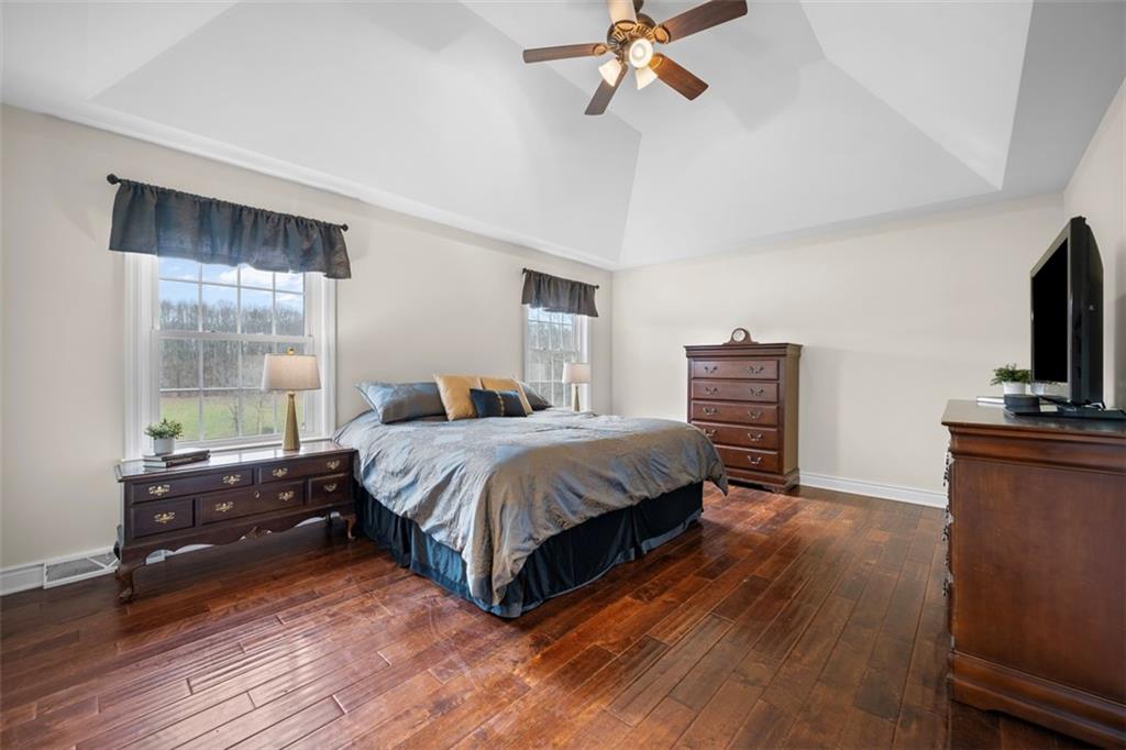 136 Hammond Road Mars, PA 16046 - Photo 21 of 48 a spacious bedroom with a bed and a flat tv screen on a dresser