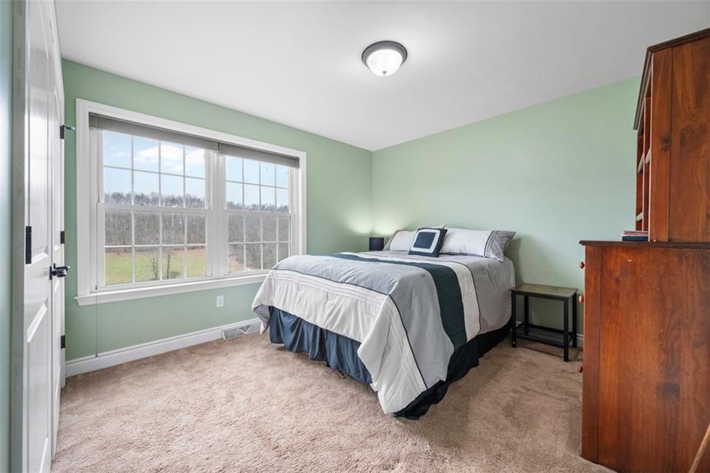 136 Hammond Road Mars, PA 16046 - Photo 30 of 48 a spacious bedroom with a bed and a window