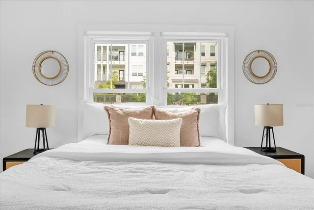 a bedroom with a large bed and a window