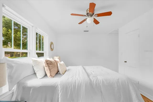 a bedroom with a bed and a large window