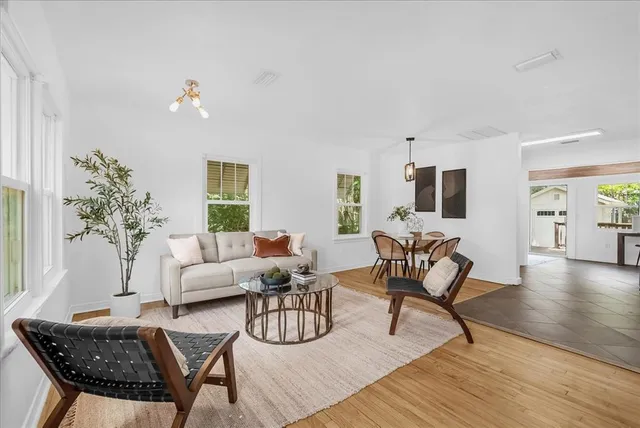 a living room with furniture and wooden floor