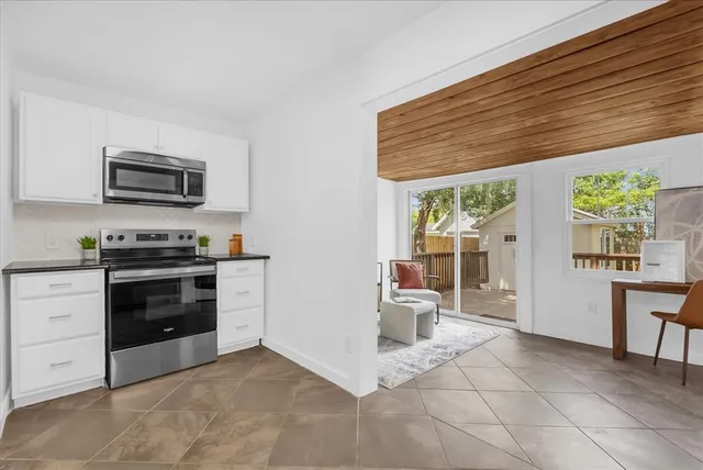 a kitchen with a stove a microwave and a counter space