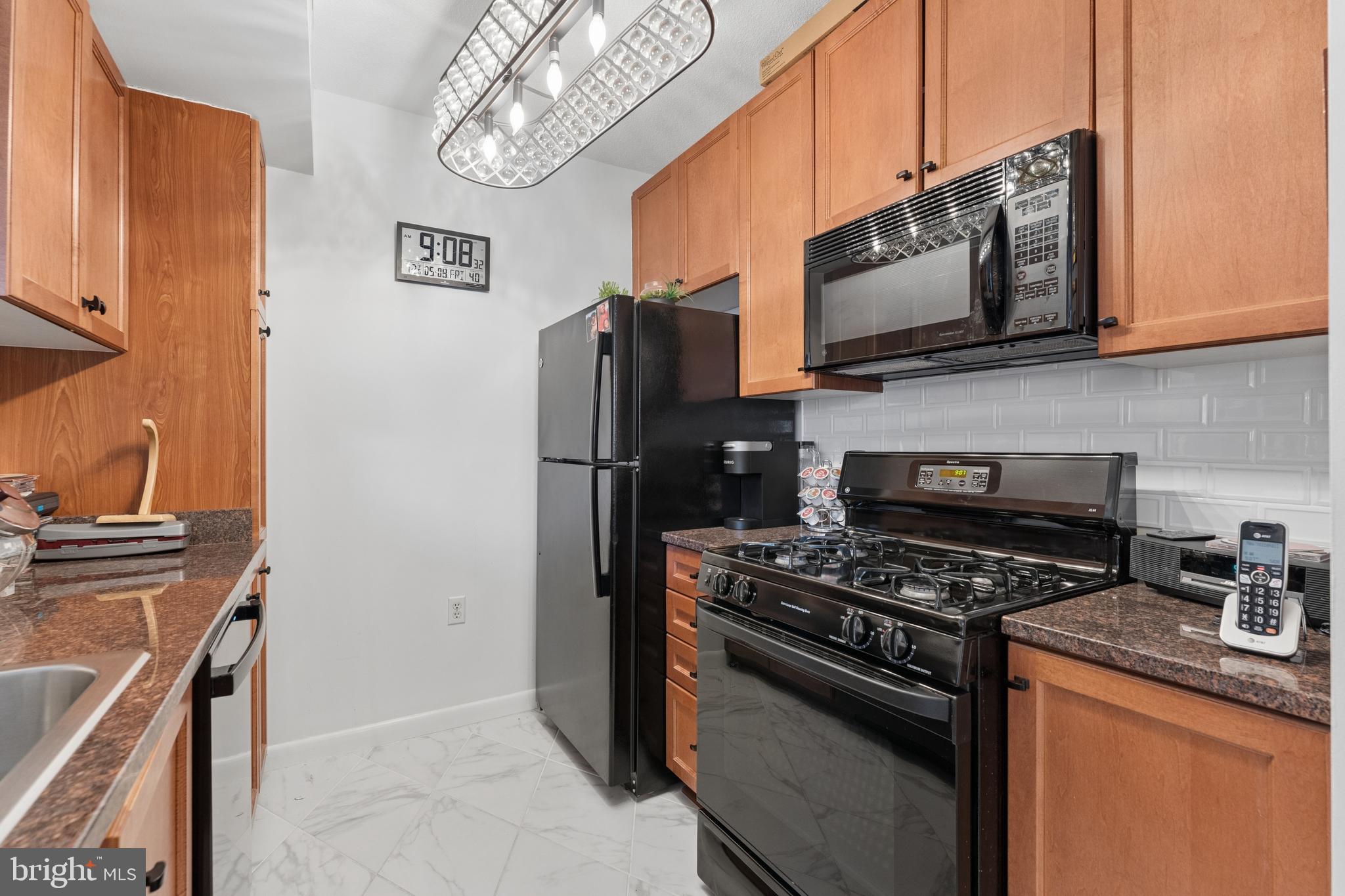 851 North Glebe Road, Unit 706 Arlington, VA 22203 - Photo 15 of 34 a kitchen with stainless steel appliances a stove a microwave and a sink