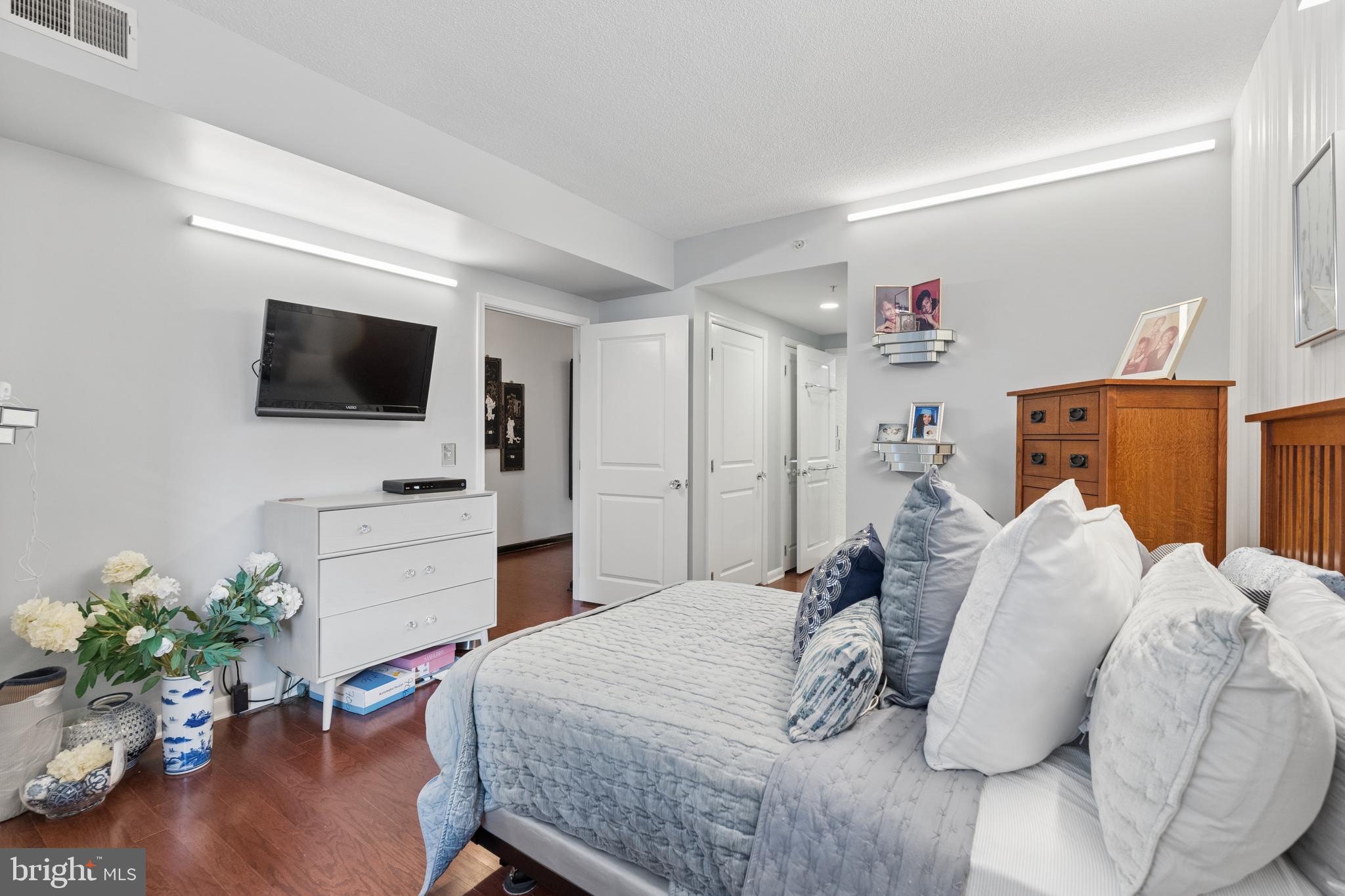 851 North Glebe Road, Unit 706 Arlington, VA 22203 - Photo 17 of 34 a bedroom with a bed and a flat screen tv