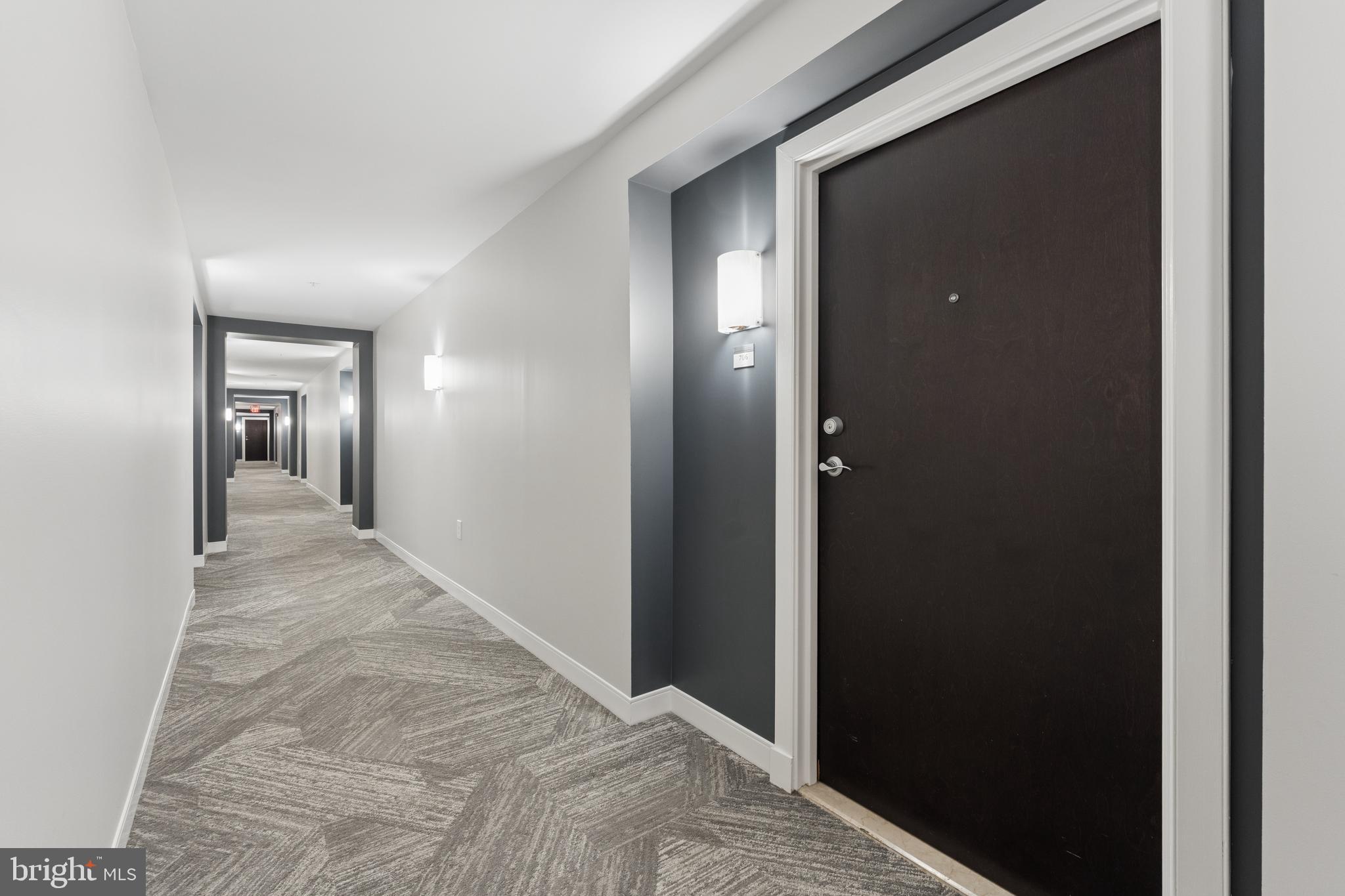 851 North Glebe Road, Unit 706 Arlington, VA 22203 - Photo 3 of 34 a view of a hallway with wooden floor