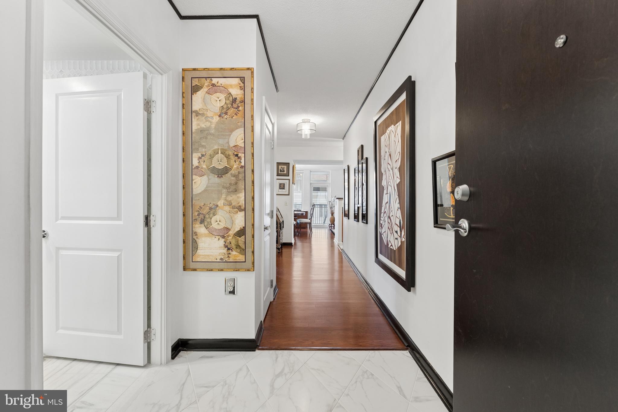 851 North Glebe Road, Unit 706 Arlington, VA 22203 - Photo 4 of 34 a hallway with wooden floor windows and stairs