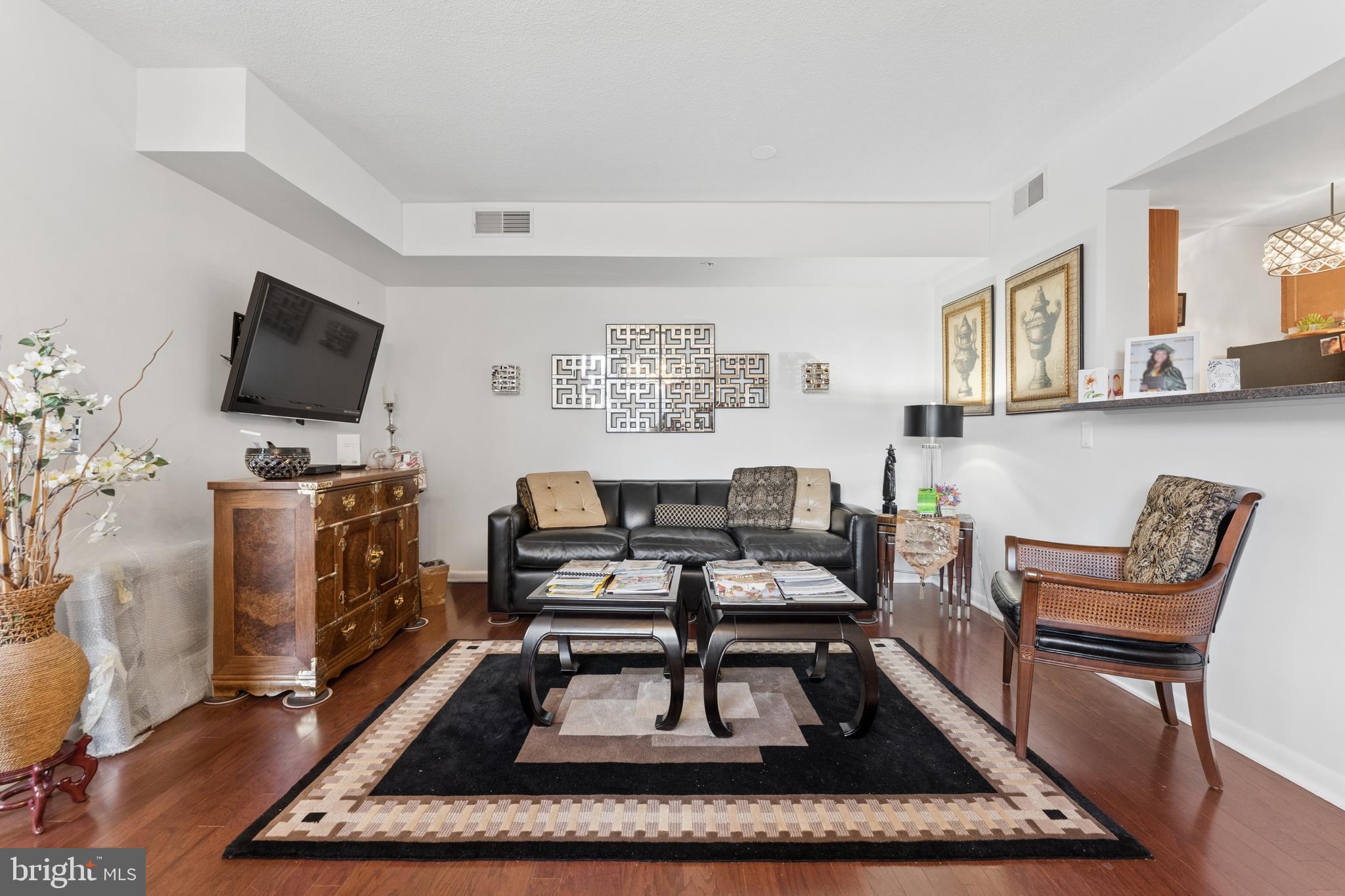 851 North Glebe Road, Unit 706 Arlington, VA 22203 - Photo 34 of 34 a living room with furniture and a flat screen tv