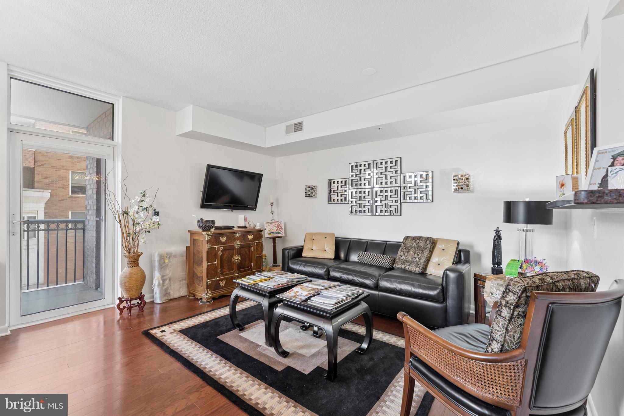 851 North Glebe Road, Unit 706 Arlington, VA 22203 - Photo 6 of 34 a living room with furniture a flat screen tv and a fireplace