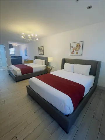 a bedroom with bed and night stand