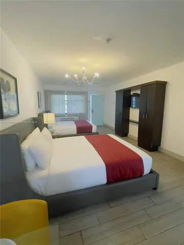 a bed room with a bed and a chair