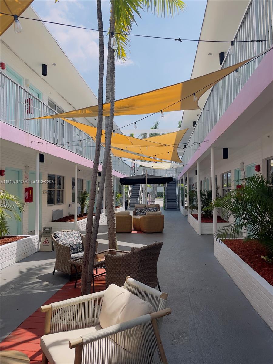 7500 Collins Avenue, Unit 112 Miami Beach, FL 33141 - Photo 10 of 10 a building outdoor space with patio furniture and potted plants