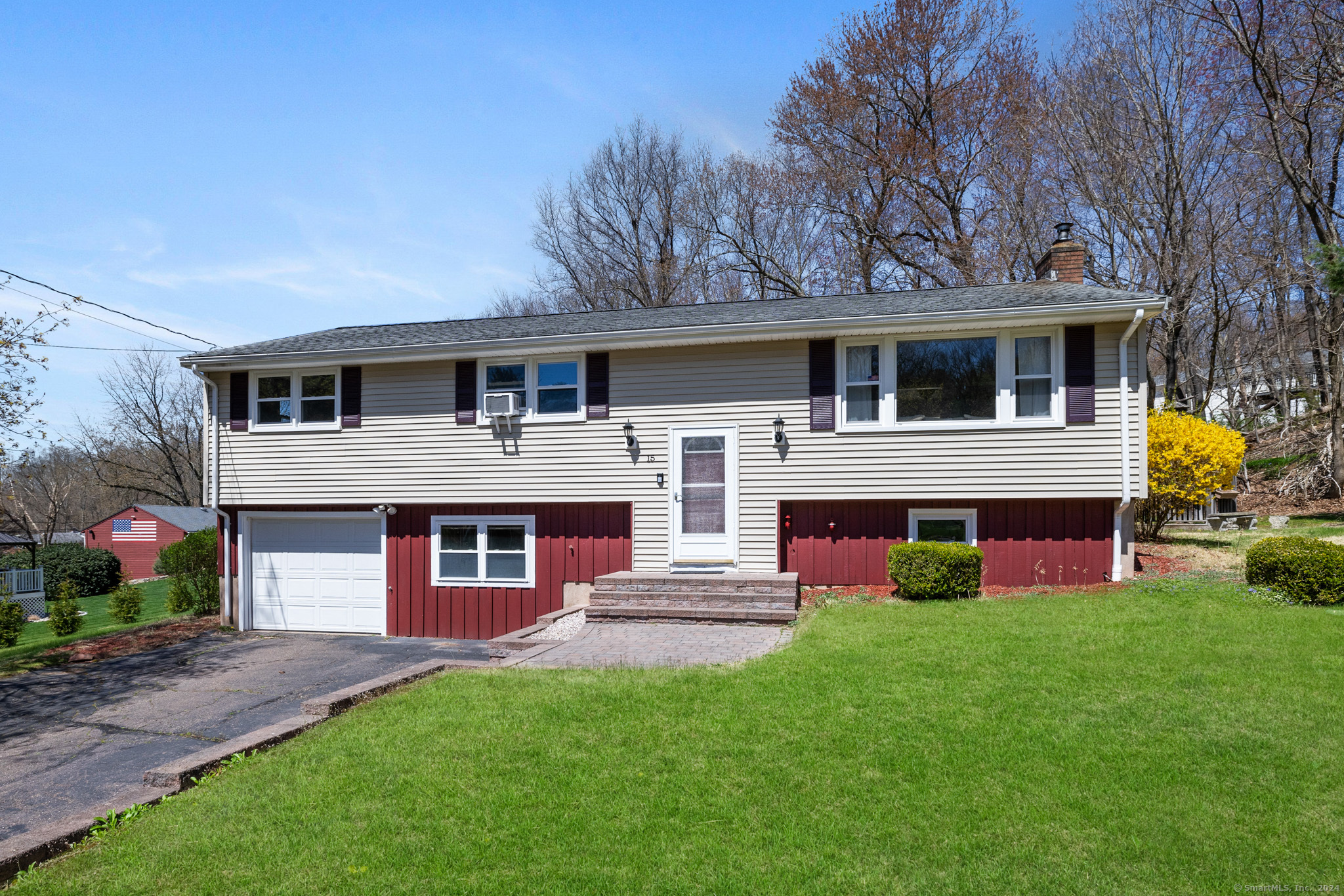 a front view of house with yard and green space
