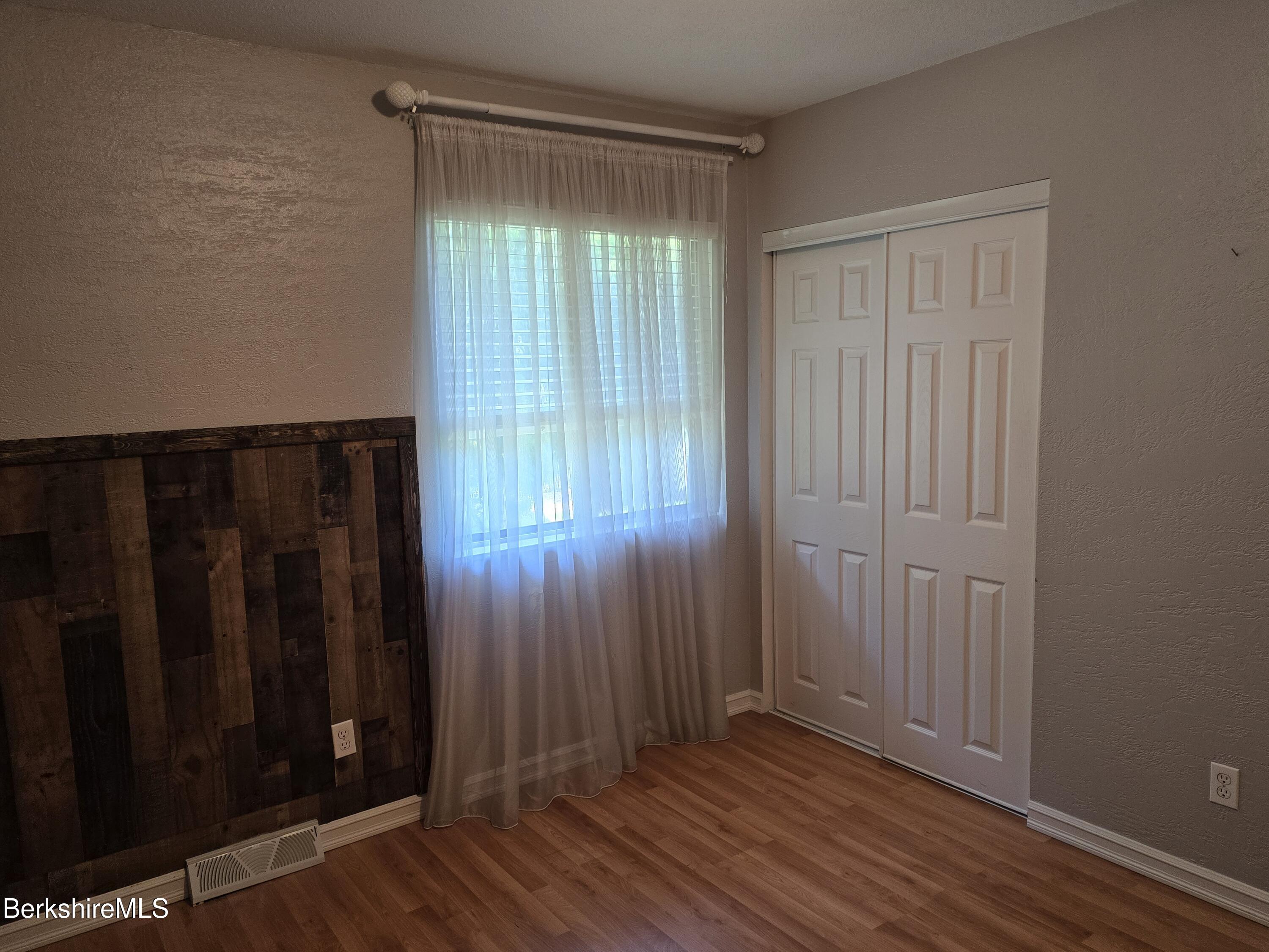 555 Russell Road, Unit J 65 Westfield, MA 01085 - Photo 15 of 20 an empty room with wooden floor