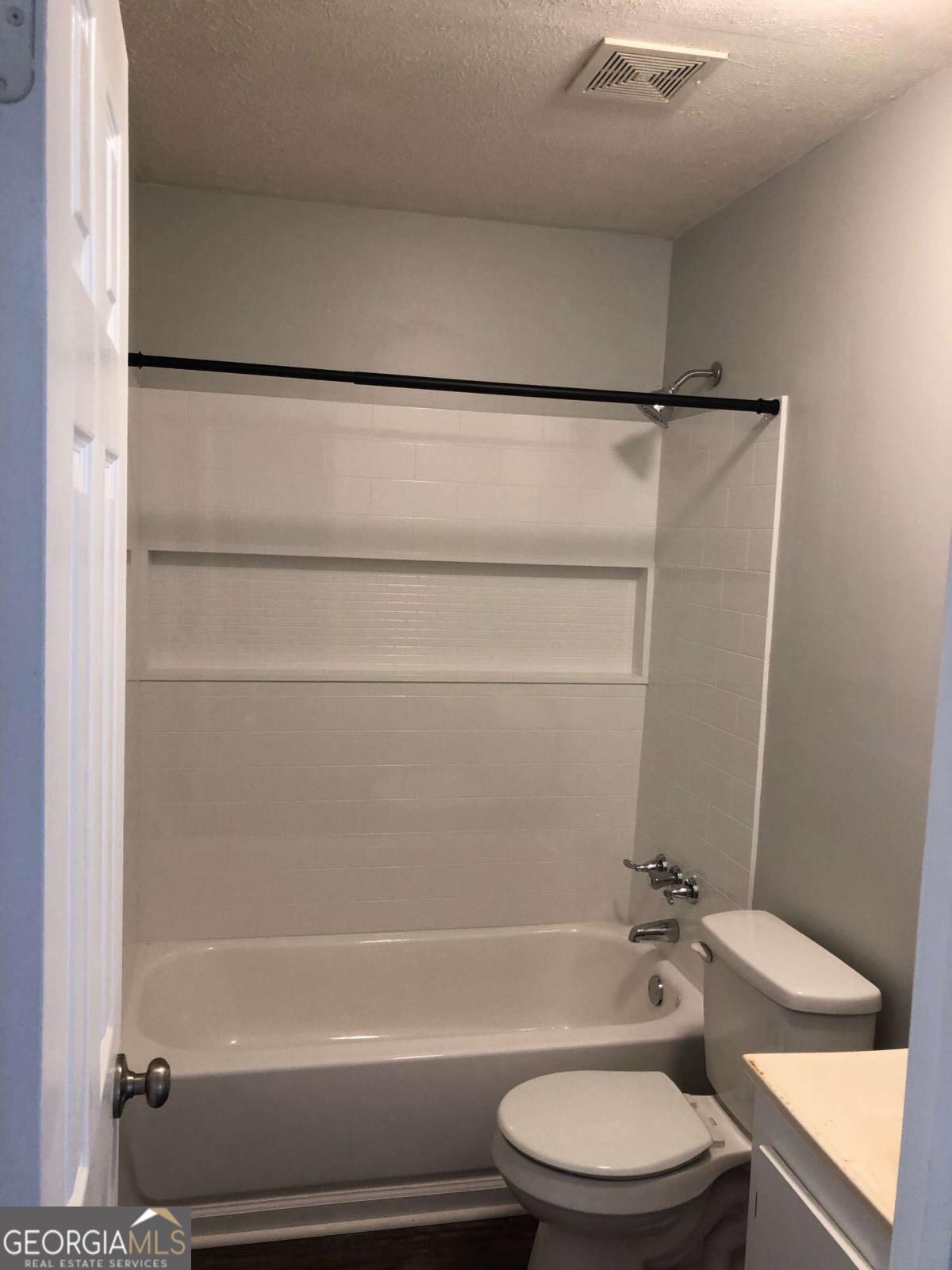 153 A Cox Road Gordon, GA 31031 - Photo 11 of 16 a bathroom with a toilet and a bathtub