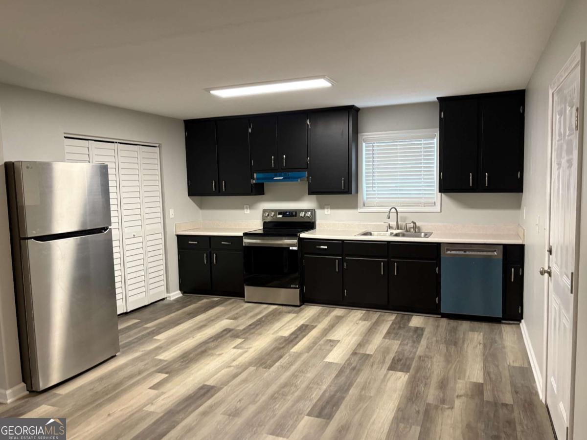 153 A Cox Road Gordon, GA 31031 - Photo 2 of 16 a kitchen with a refrigerator and a sink