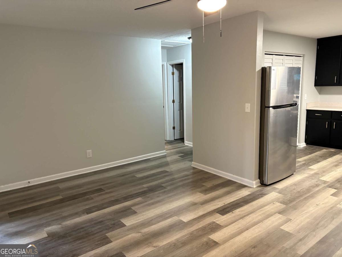 153 A Cox Road Gordon, GA 31031 - Photo 4 of 16 a view of a kitchen with wooden floor and a refrigerator