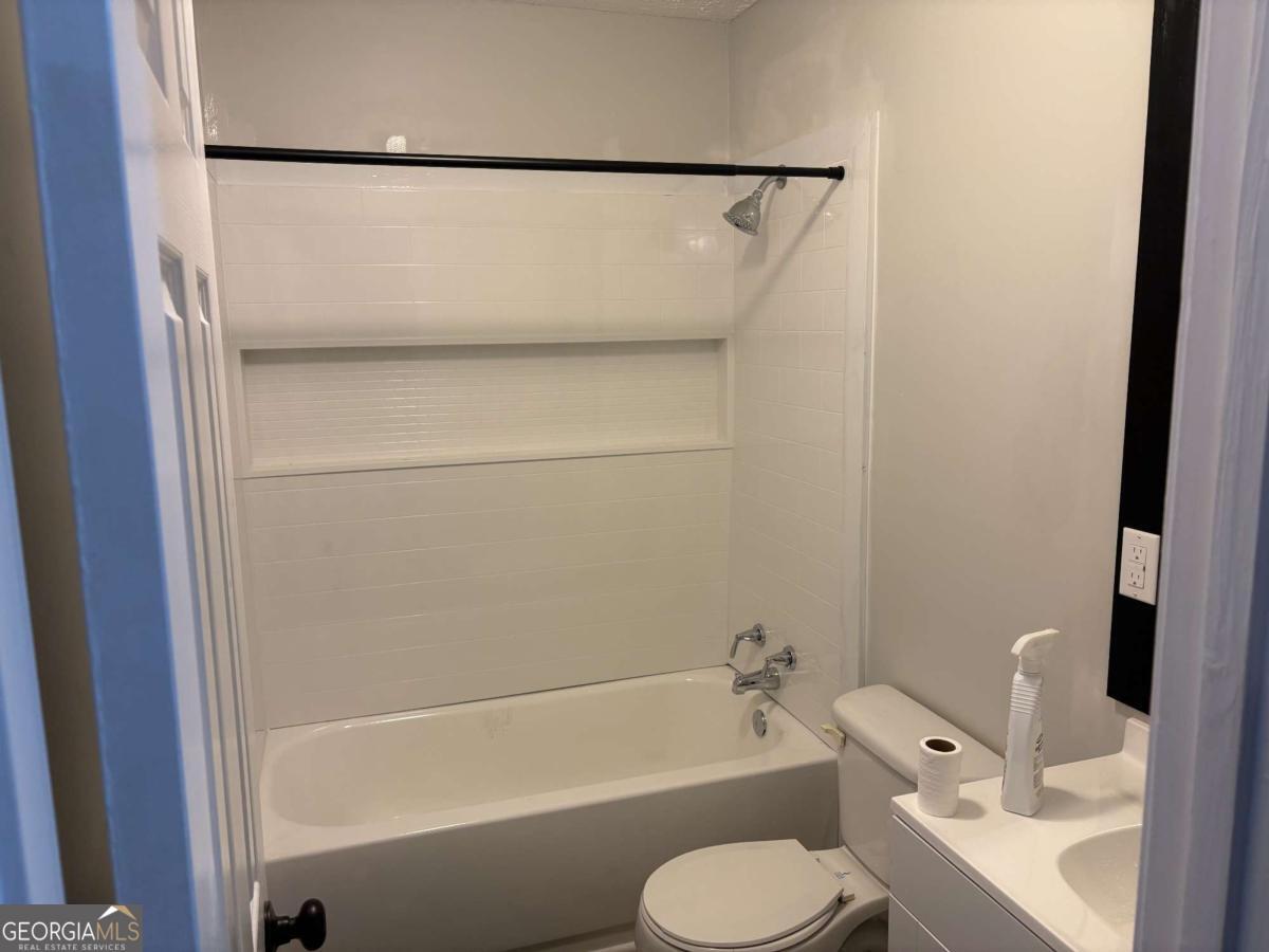 153 A Cox Road Gordon, GA 31031 - Photo 10 of 16 a bathroom with a toilet and a bath tub