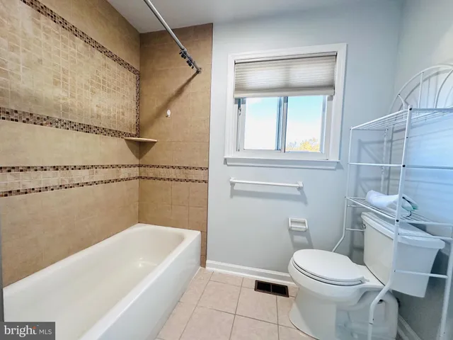 a bathroom with a toilet a sink and bathtub