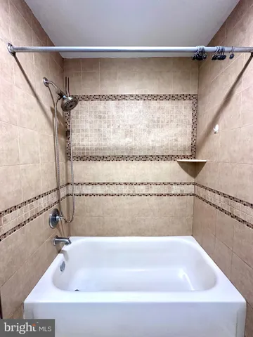 a bathroom with a shower and a bath tub