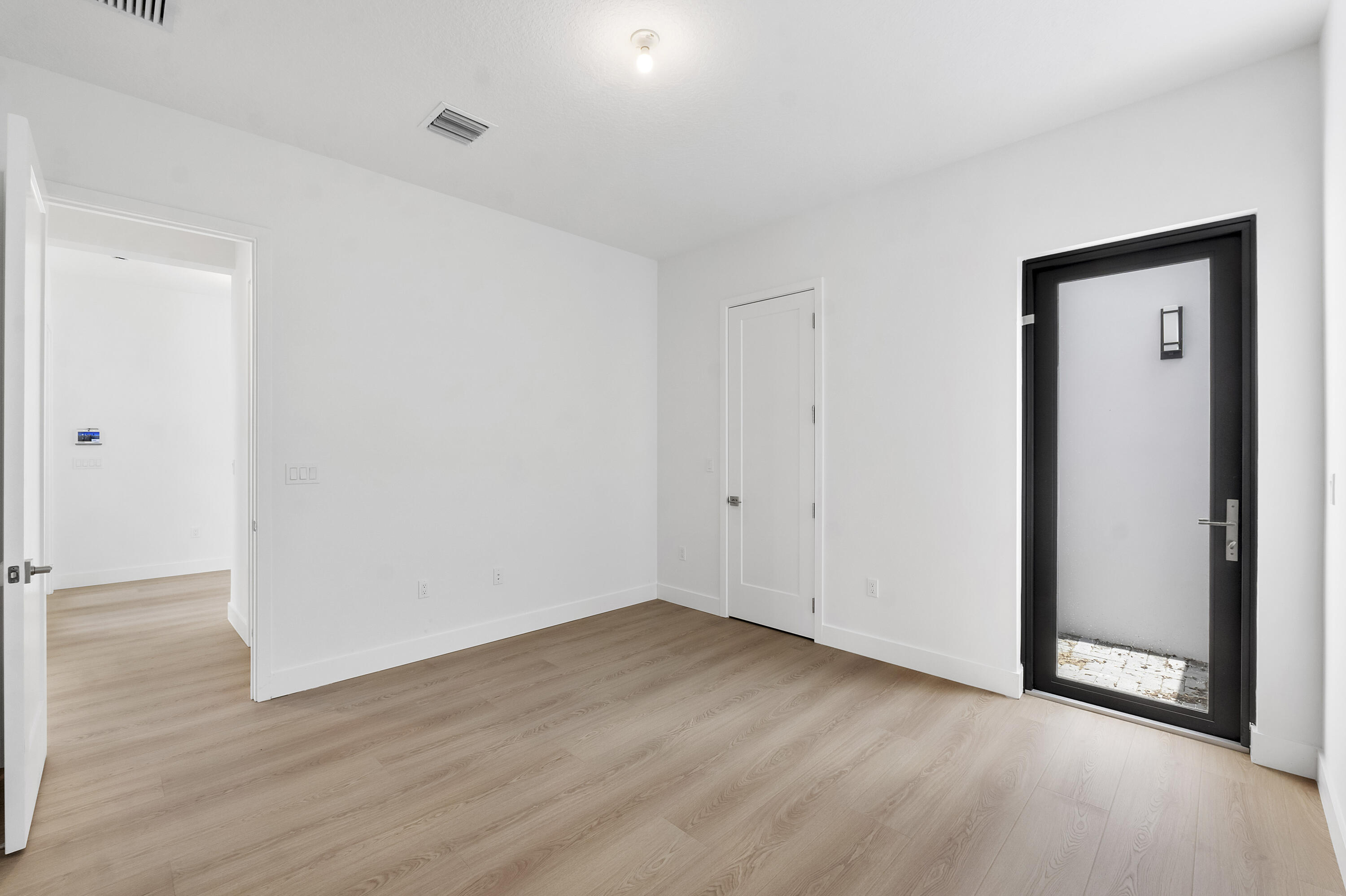 9322 Sunflower Mdw Road Boca Raton, FL 33434 - Photo 22 of 87 a view of an empty room with wooden floor and closet