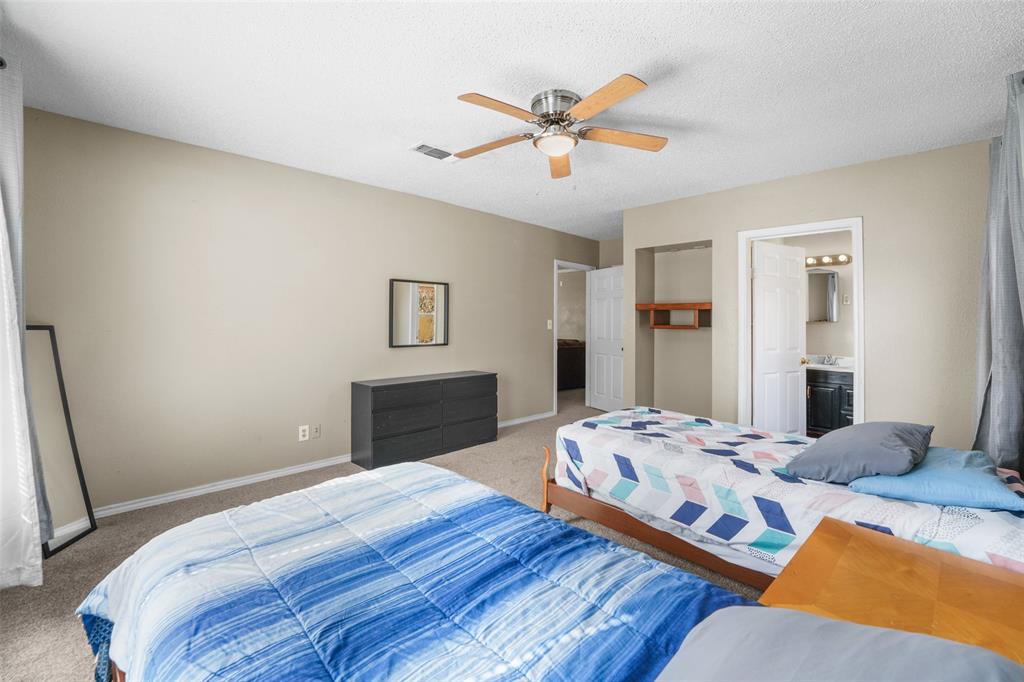 1145 Jefferson Road Paris, TX 75460 - Photo 11 of 17 a bedroom with a bed and wooden floor