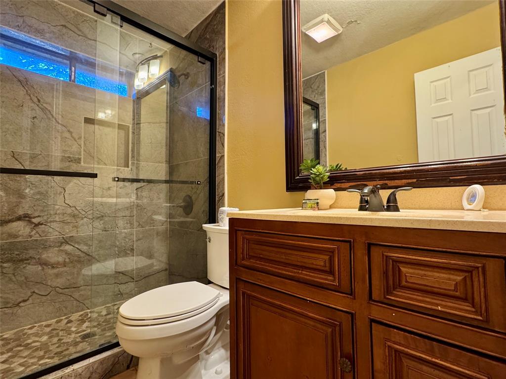 4508 Estes Park Road Haltom City, TX 76137 - Photo 13 of 17 a bathroom with a sink a toilet and shower