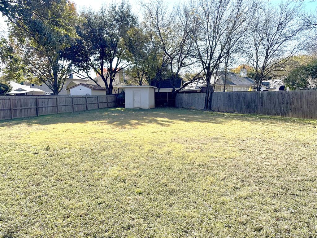 4508 Estes Park Road Haltom City, TX 76137 - Photo 16 of 17 a swimming pool with trees in the background