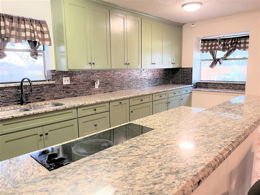 4508 Estes Park Road Haltom City, TX 76137 - Photo 3 of 17 a bathroom with a granite countertop sink and a large mirror