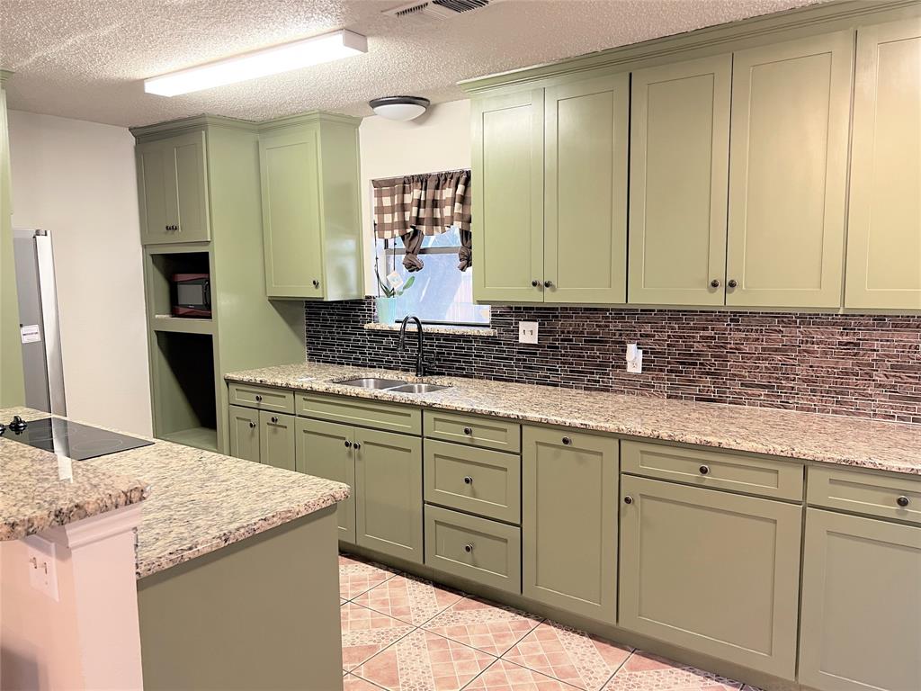 4508 Estes Park Road Haltom City, TX 76137 - Photo 5 of 17 a bathroom with a granite countertop sink and a mirror