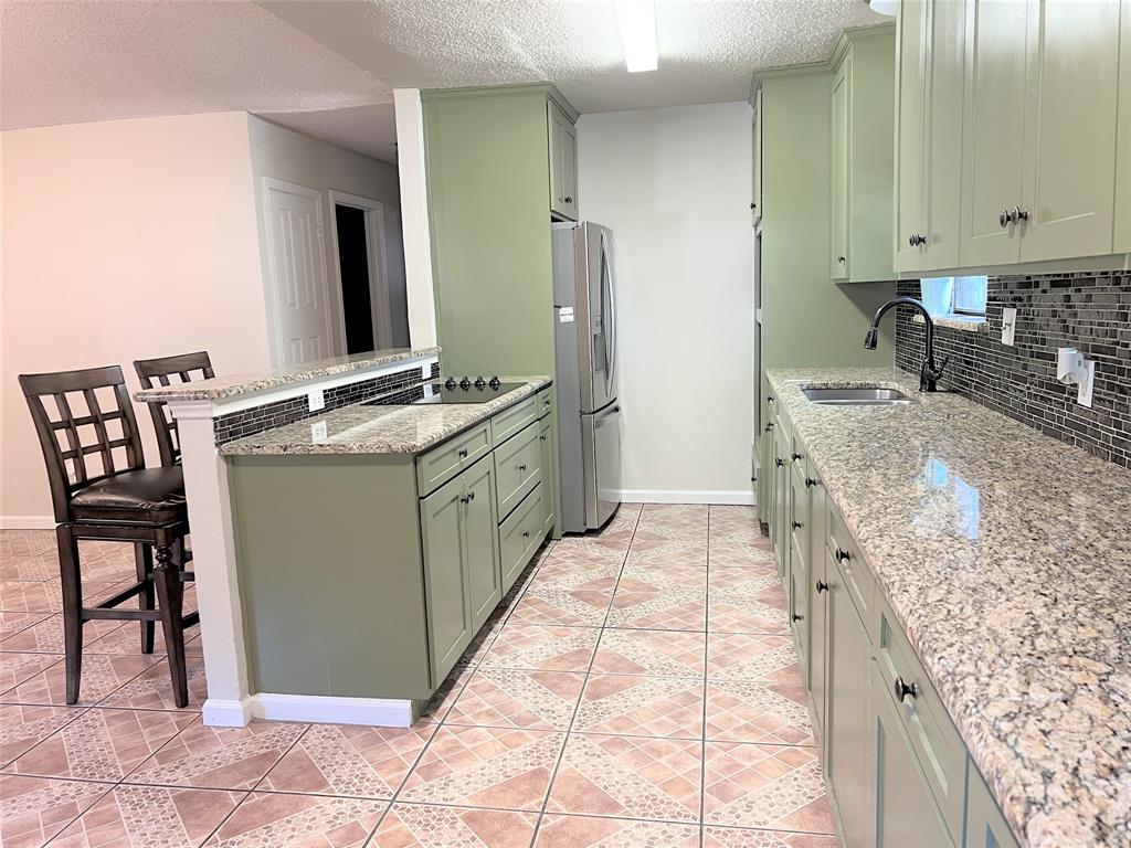 4508 Estes Park Road Haltom City, TX 76137 - Photo 6 of 17 a spacious bathroom with a granite countertop sink and a mirror