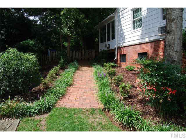 2808 Rothgeb Drive Raleigh, NC 27609 - Photo 21 of 25 BRICK WALKWAY AND LANDSCAPING AROUND SIDE OF THE HOME