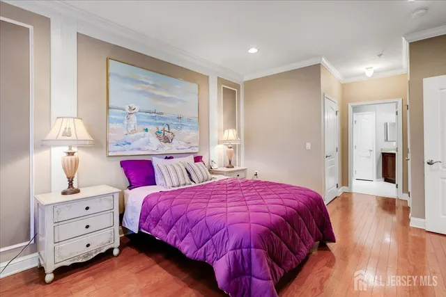 a spacious bedroom with a bed and a lamp