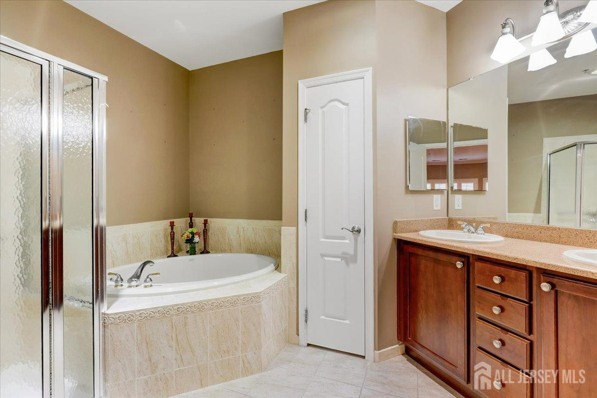 3205 Falston Circle Old Bridge, NJ 08857 - Photo 14 of 44 a bathroom with a tub sink and mirror
