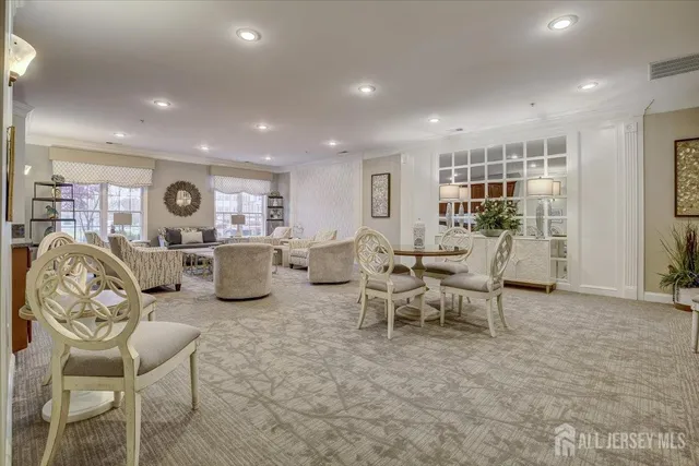 a living room with lots of furniture and kitchen view