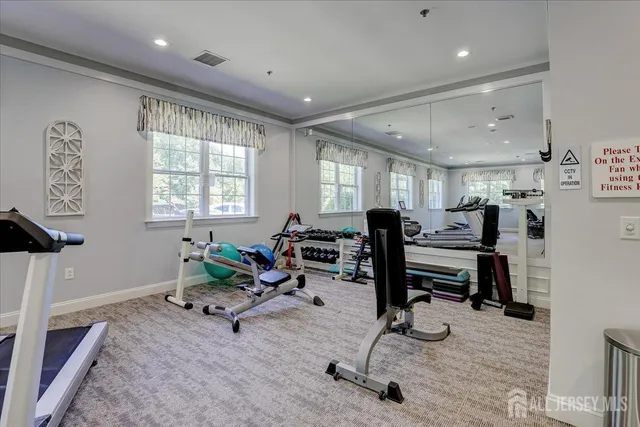 a living room with furniture gym equipment and a window