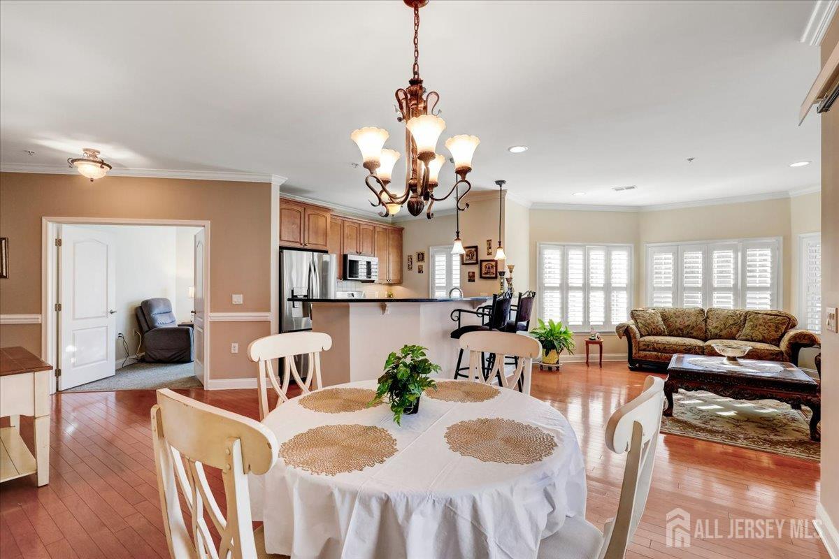 3205 Falston Circle Old Bridge, NJ 08857 - Photo 7 of 44 a view of a dining room with furniture a chandelier and wooden floor