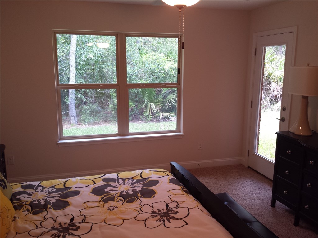88397 Maybourne Road Yulee, FL 32097 - Photo 16 of 35 a bedroom with a bed and a window