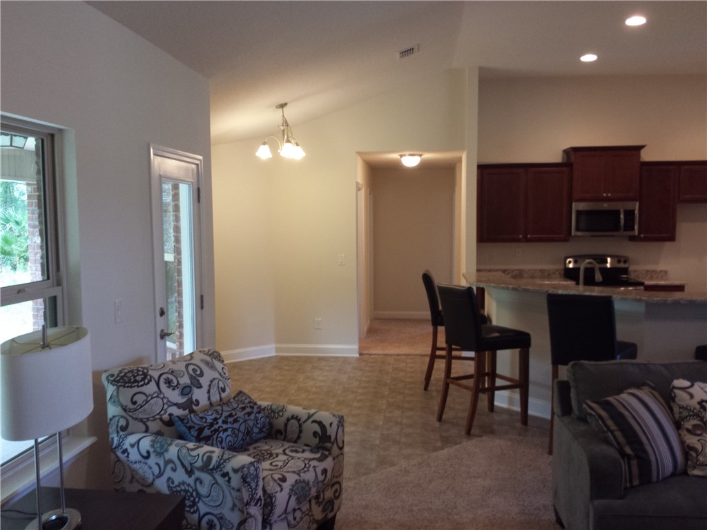 88397 Maybourne Road Yulee, FL 32097 - Photo 19 of 35 a living room with furniture and a lamp