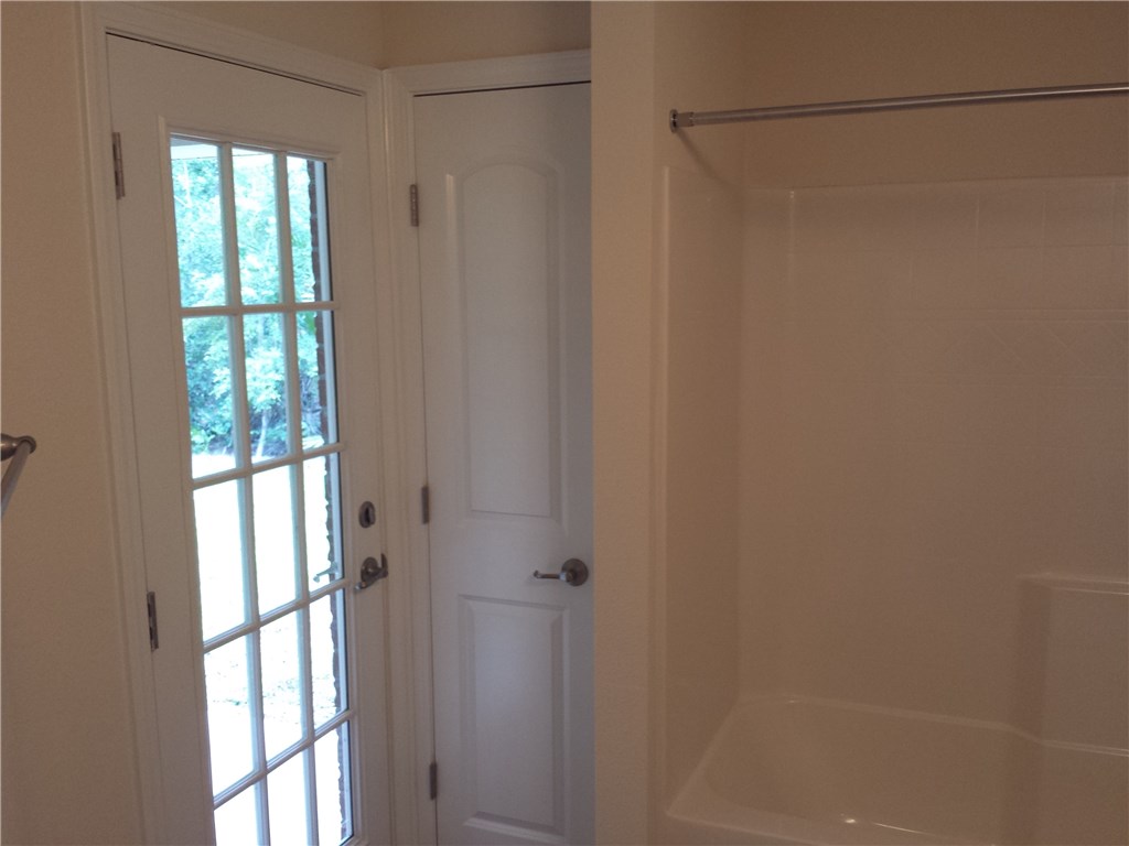 88397 Maybourne Road Yulee, FL 32097 - Photo 24 of 35 a bathroom with a glass shower door