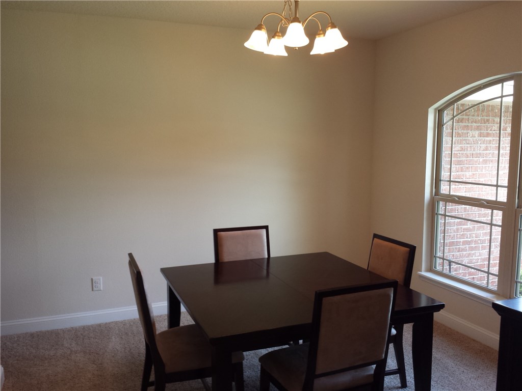 88397 Maybourne Road Yulee, FL 32097 - Photo 9 of 35 a view of a dining room with a table and chairs