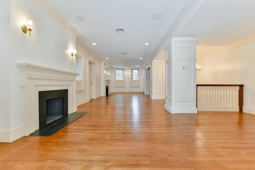 17 Willow Street, Unit 1 Boston, MA 02108 - Photo 11 of 35 a view of a hallway with wooden floor and a fireplace