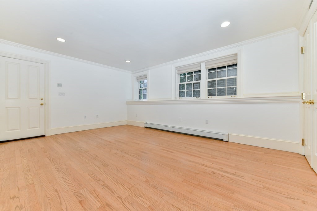17 Willow Street, Unit 1 Boston, MA 02108 - Photo 22 of 35 an empty room with wooden floor and windows